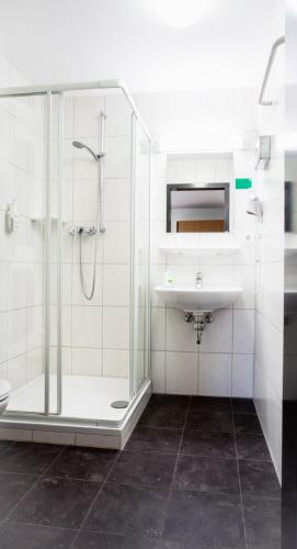 a bathroom with a shower and a sink at Ecoinn in Esslingen