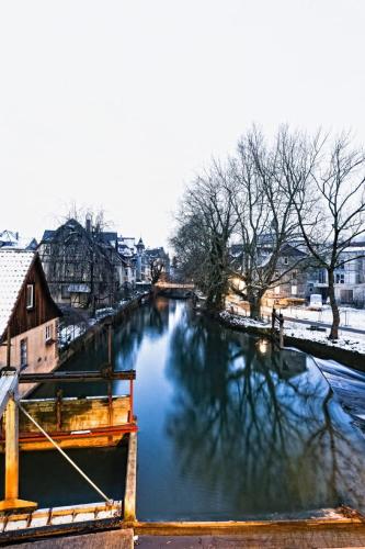 a river in a city with snow on it at Ecoinn in Esslingen