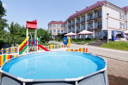 a pool with a playground in front of a building at VitaPark Borysfen in Kyiv