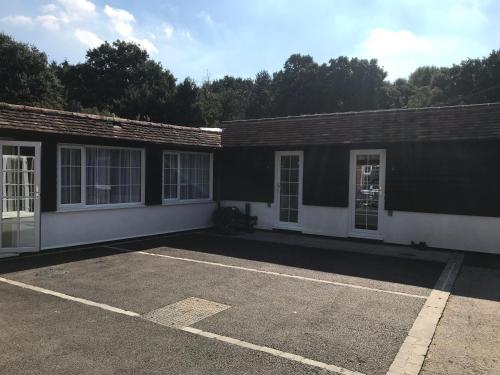 an empty parking lot in front of a building at Fornham Guest House in Chertsey
