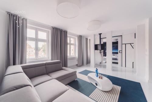 salon z kanapą i stołem w obiekcie Kosmos 9 - Apartament Orbita w Toruniu