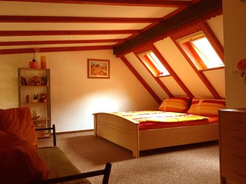 a bedroom with a bed in a attic at Ferienhaus Hagenwinkel in Gernrode - Harz