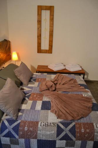 a bed with a blanket on it in a room at Il Riuscello in Tuscania