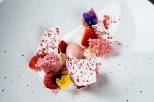 a pile of desserts on a white plate with strawberries at Hotel Gasthof Lamm in Bregenz