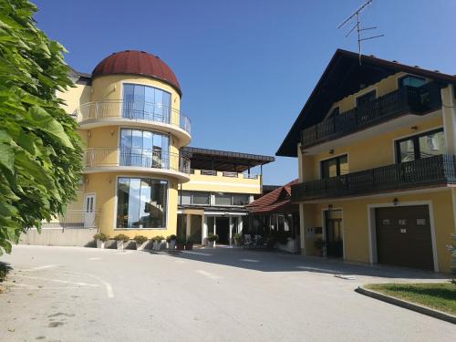 a large yellow building with a dome on top of it at Gostilna in prenočišče KOCJAN in Bizeljsko