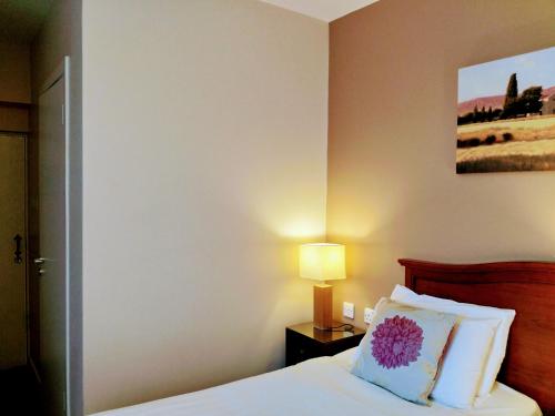 a bedroom with a bed with a pillow and a lamp at Thirteen On The Green - Eyre Square in Galway