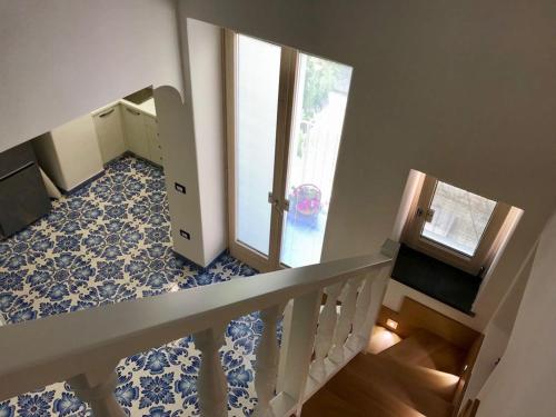 a room with a staircase and a stair case at Casetta del pescatore in Ischia