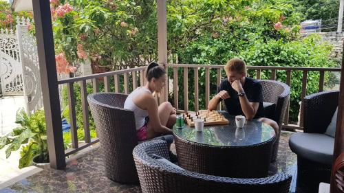 two people sitting at a table playing chess at Godiva Villa Phu Quoc in Phu Quoc