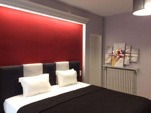 a bedroom with a black and white bed with a red wall at VILLA 87 - AY CHAMPAGNE in Ay