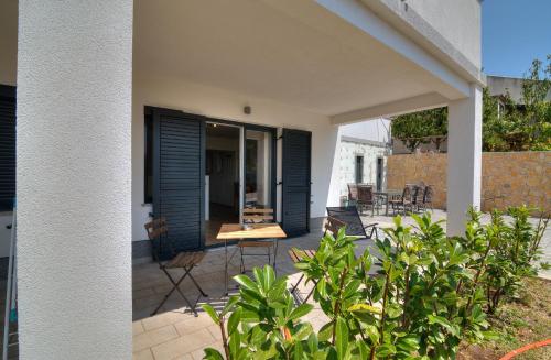 a patio with blue shutters on a house at BC Eleven - mit Zentralheizung in Senj