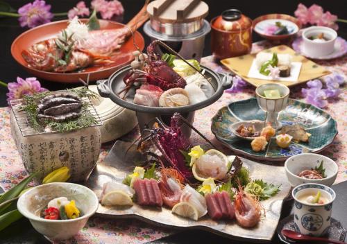 a table with many plates of food on it at Atagawa Yamatokan in Higashiizu