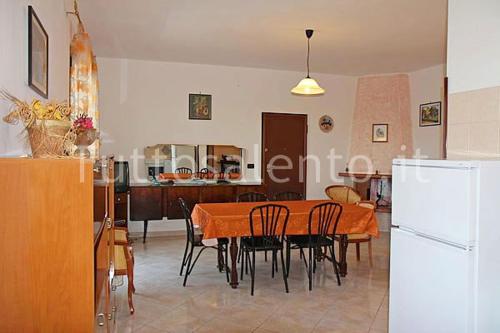 uma cozinha e sala de jantar com mesa e cadeiras em La Casa Di Madia em Gagliano del Capo