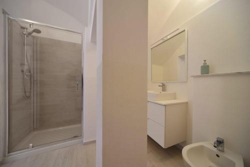 a white bathroom with a shower and a sink at Bistrot del mare in Santo Stefano al Mare