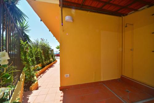 a balcony of a house with a yellow wall at Bistrot del mare in Santo Stefano al Mare