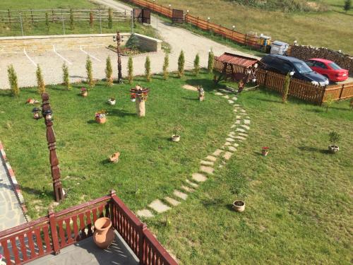 a garden with a stone path in the grass at Pensiunea Zana Muntilor in Piatra Fantanele
