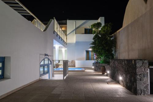 an external view of a house at night at Tristhenia in Perissa