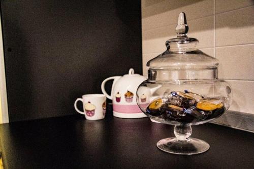 a glass bowl filled with candy on top of a table at Little House in Modugno