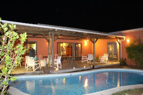 a villa with a swimming pool at night at Gite des Acacias in Union Vale