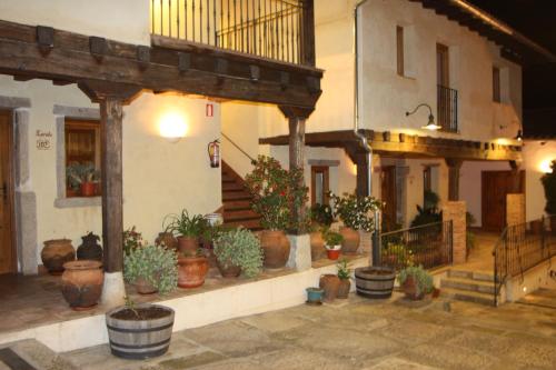 a group of potted plants sitting outside of a building at Hotel Rural Abadía de Yuste in Cuacos de Yuste