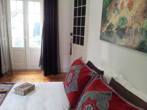 a bedroom with a bed with a pillow and a window at Whatever Art B&B in Lisbon