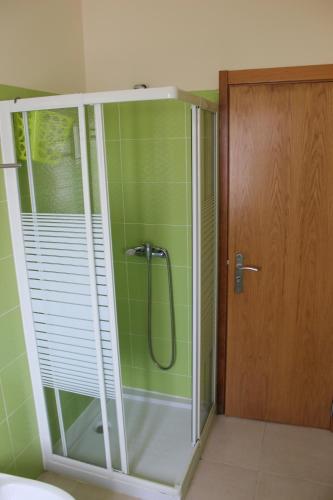 a shower with a glass door in a bathroom at VillasFerrel - Cosy Apartment in Ferrel