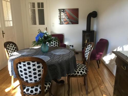 a dining room with a table with chairs and a fireplace at Hamburg Center Island in Hamburg