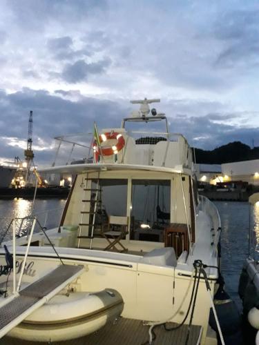 a white boat docked at a dock in the water at YachtAnnablu in Portovenere