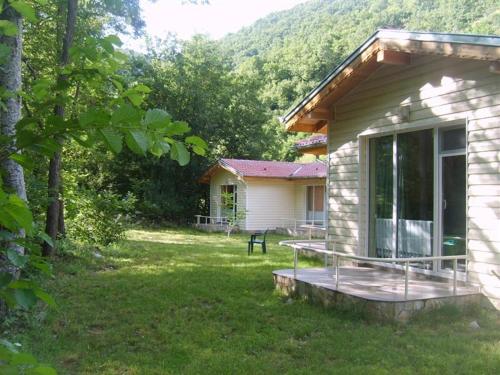 a house with a deck next to a yard at Hotel Valdis in Pastra