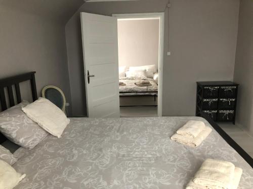 a bedroom with a bed with two towels on it at Skrunda Apartments Centrum in Skrunda