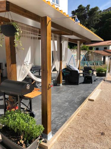 an outdoor patio with a gazebo with chairs and tables at Quinta da Villa in Cascais