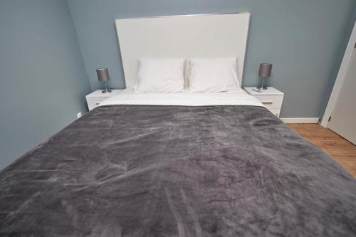 a bedroom with a large bed with two night stands at Quinta da Villa in Cascais