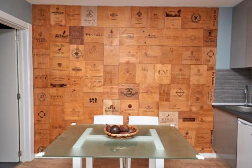 a table and chairs in a kitchen with a wooden wall at Quinta da Villa in Cascais