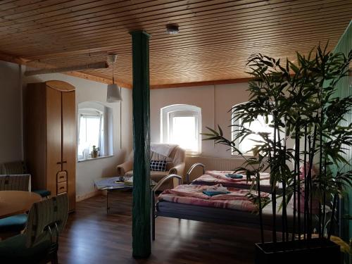 Haus am Sachsenring في هوينشتاين-إرنستال: غرفة نوم بسرير وسقف خشبي