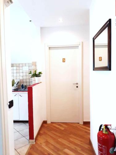 a hallway with a white door and a kitchen at Porta Maggiore GH Locazione Turistica in Rome