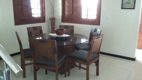 a dining room table with chairs and a bowl on it at Casa de Praia com Piscina in Luis Correia