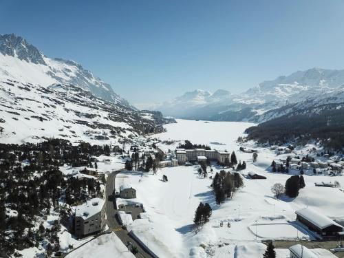 a town in the snow on a mountain at B & B Longhin in Maloja