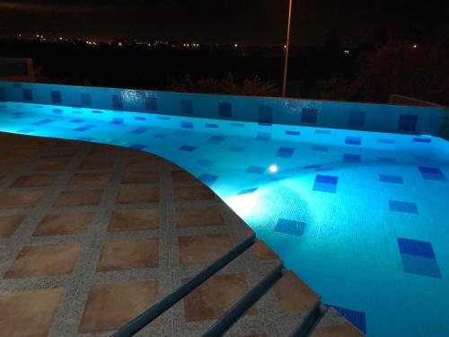 a swimming pool lit up at night at Playa y alberca en Zona Marina in Mazatlán