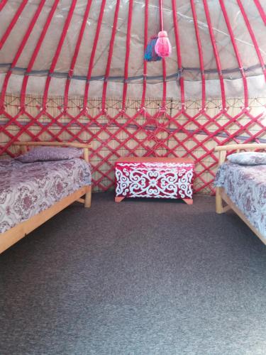 a room with two beds in a yurt at Yurt camp Tosor in Tossor