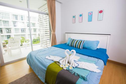 1 dormitorio con 1 cama con toallas en At Seacondo-1 Bedroom-A12, en Klong Muang Beach