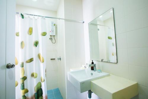 Un baño blanco con lavabo y espejo. en At Seacondo-1 Bedroom-A25, en Klong Muang Beach
