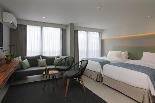 Ένα ή περισσότερα κρεβάτια σε δωμάτιο στο Kollektiv Hotel