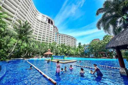 a group of people in a pool at a hotel at Ocean Sonic Resort Sanya in Sanya