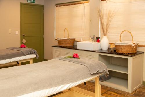 a hospital room with two beds and a sink at The Ravenala Attitude in Balaclava