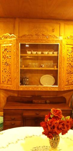 a bathroom with a sink and a vase of flowers at Umbrella group of House Boat in Srinagar