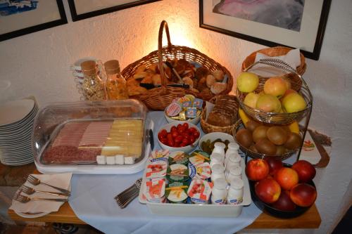 a table topped with food and fruit on a table at Hotel Leitgebhof in Innsbruck