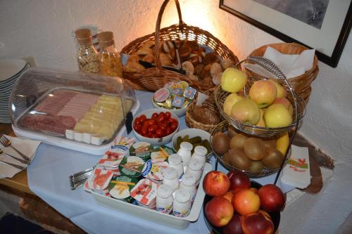 a table topped with a buffet of food and fruit at Hotel Leitgebhof in Innsbruck
