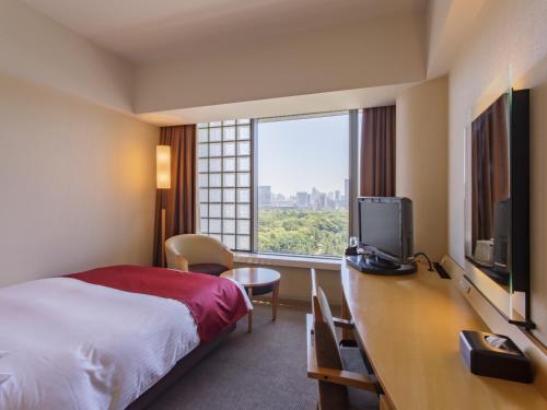 a hotel room with a bed and a large window at Hotel Grand Arc Hanzomon in Tokyo