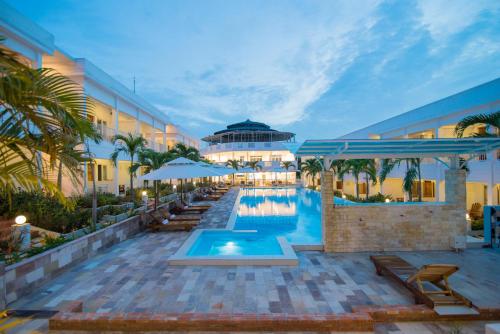 a resort with a swimming pool and a building at Palma Resort in Phu Quoc