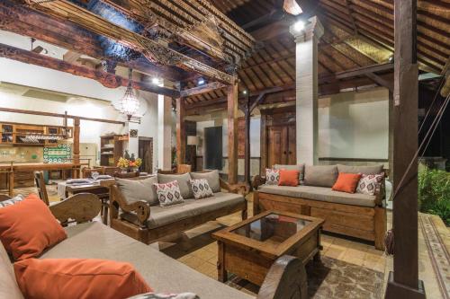 a large living room with couches and a table at Casa Jimbaran Villa in Jimbaran