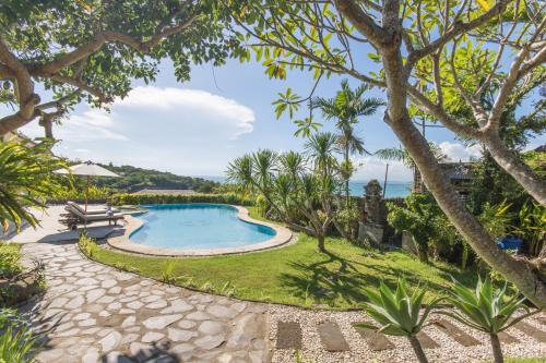 an image of a swimming pool in a resort at Casa Jimbaran Villa in Jimbaran
